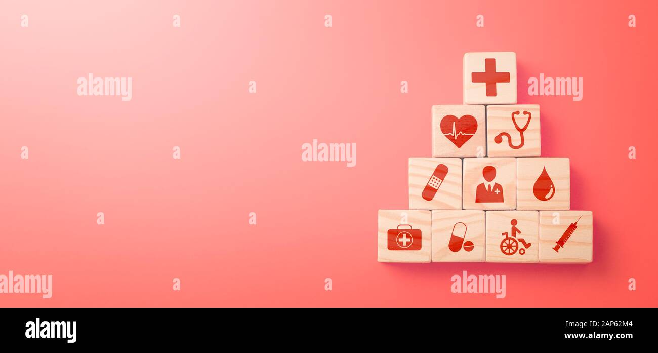 Hand arranging wood block with healthcare medical icon. Health insurance - concept. Stock Photo
