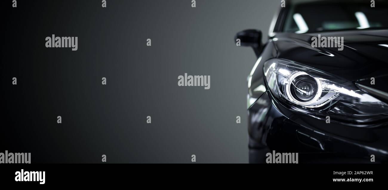 Black modern car closeup on black background. Stock Photo