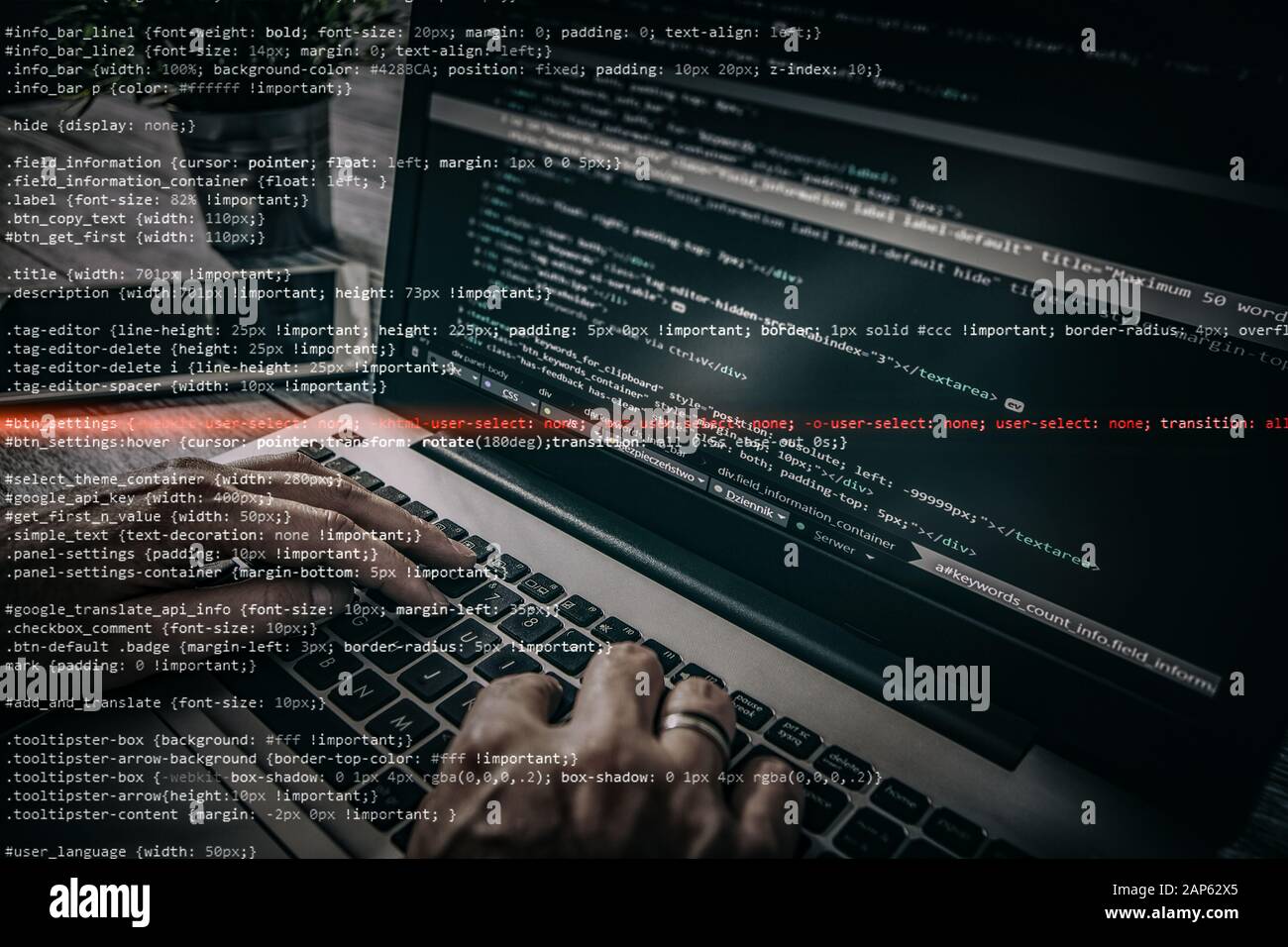 Hacker using laptop. Lots of digits on the computer screen. Stock Photo