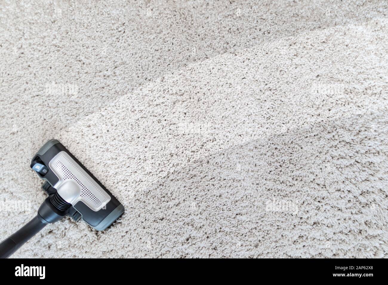 Cleaning carpet hoover. Carpet texture background. Stock Photo