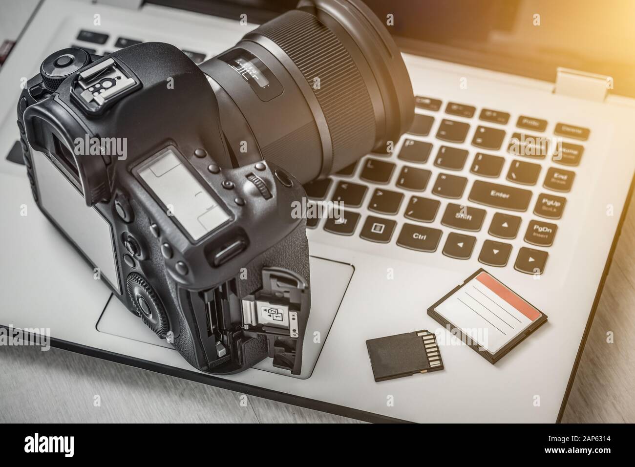 Modern digital DSLR camera and computer workstation. Photography and videography concept. Stock Photo