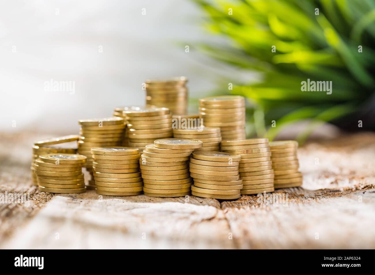 golden coin money stack save savings profit wooden table - stock image Stock Photo