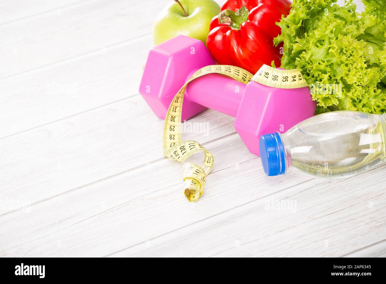 Fitness concept with dumbbells and healthy food. Stock Photo