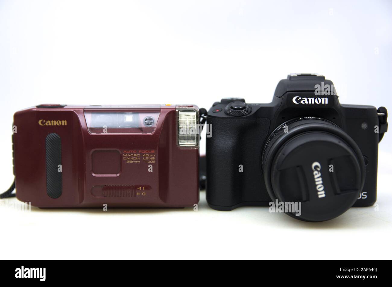 2020.Spain. Two Canon cameras, the one on the left is the compact reel model: AF35J. The one on the right a canon m50 mirrorles of interchangeable obj Stock Photo