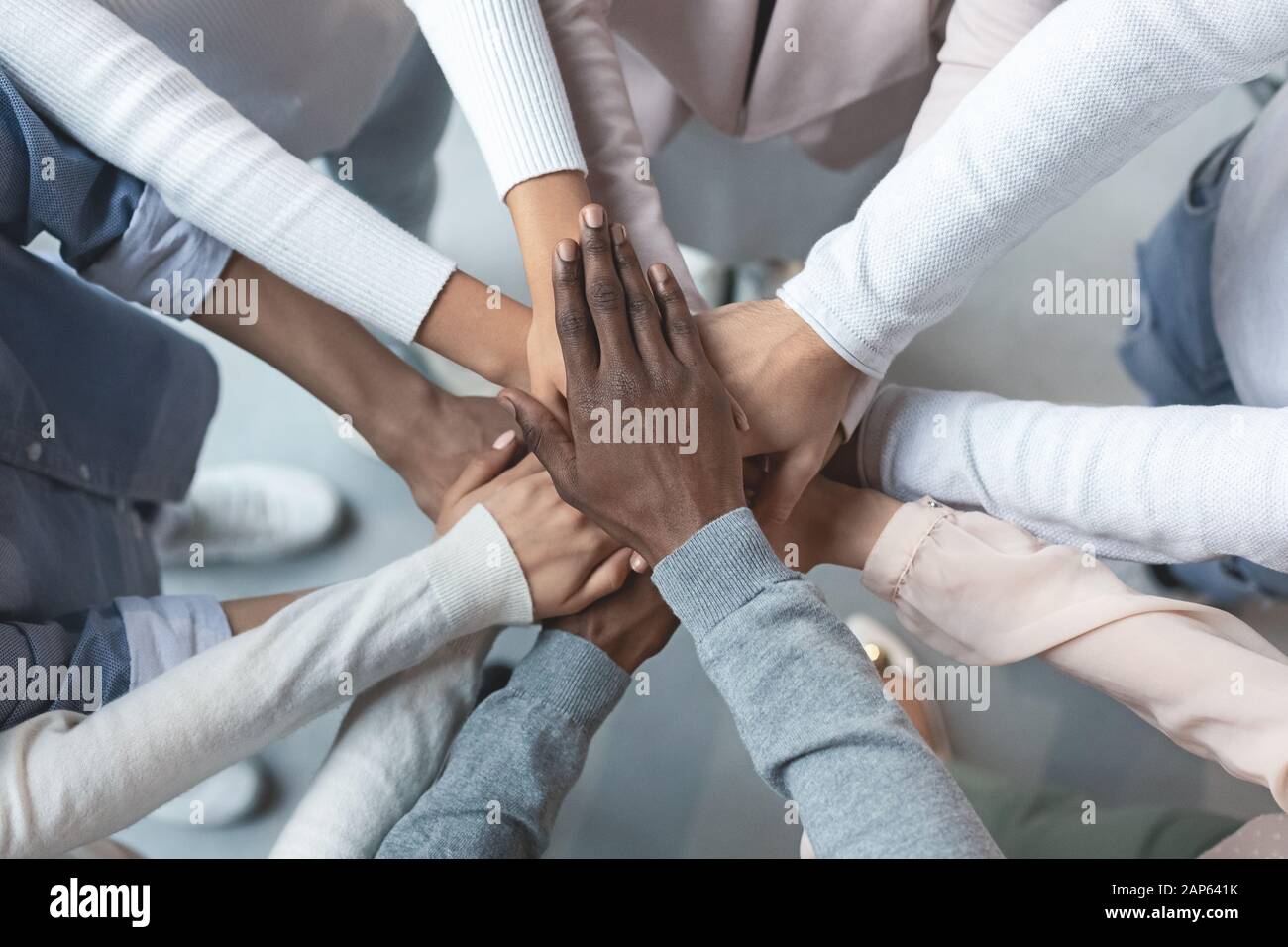 International business team putting hands together in cooperation Stock Photo
