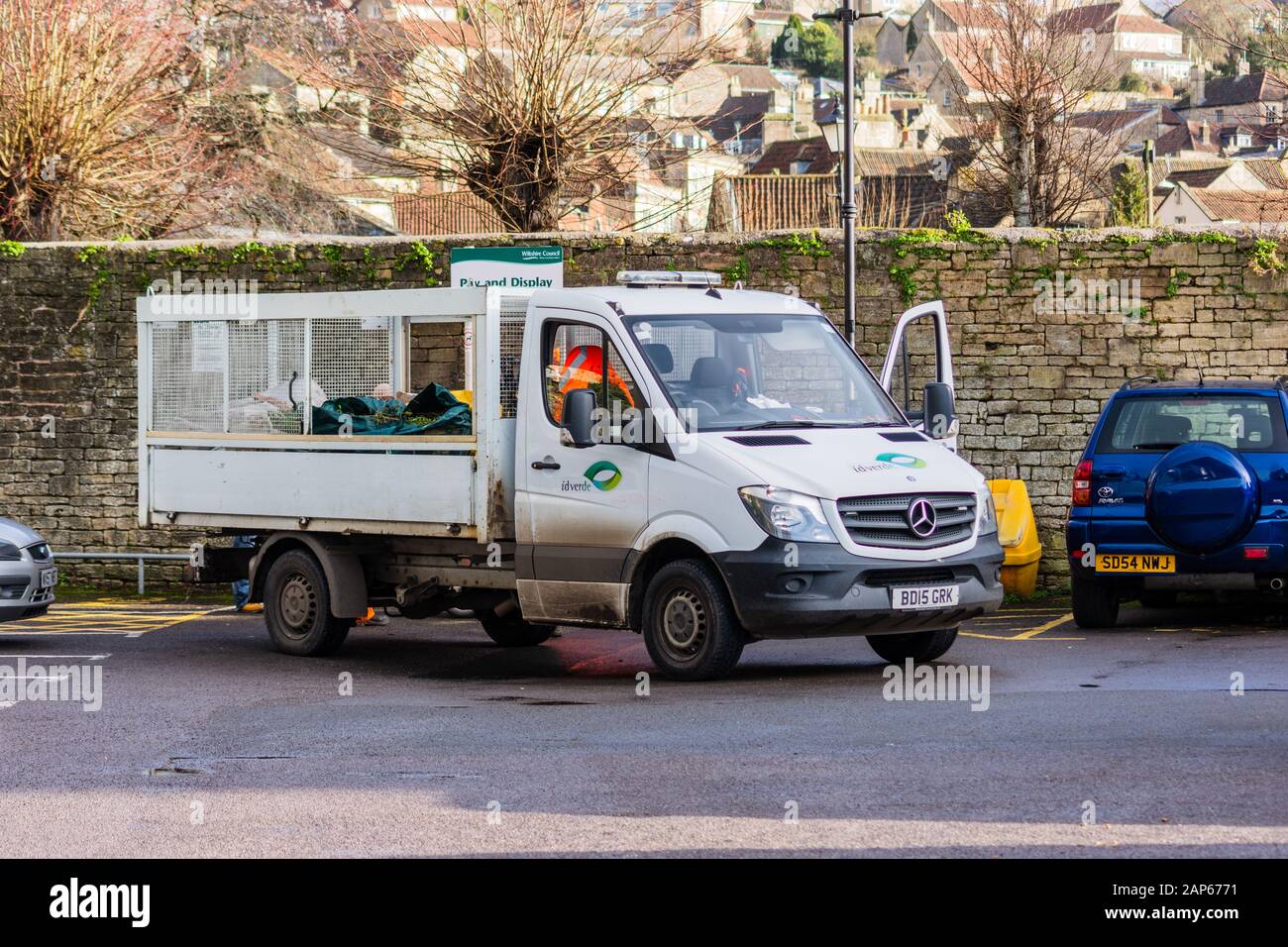 A Mercedes caged flatbed truck with the company logo "Id Verde" on the door  stopped in a car park in Bradford on Avon as the staff carry out grounds  Stock Photo -