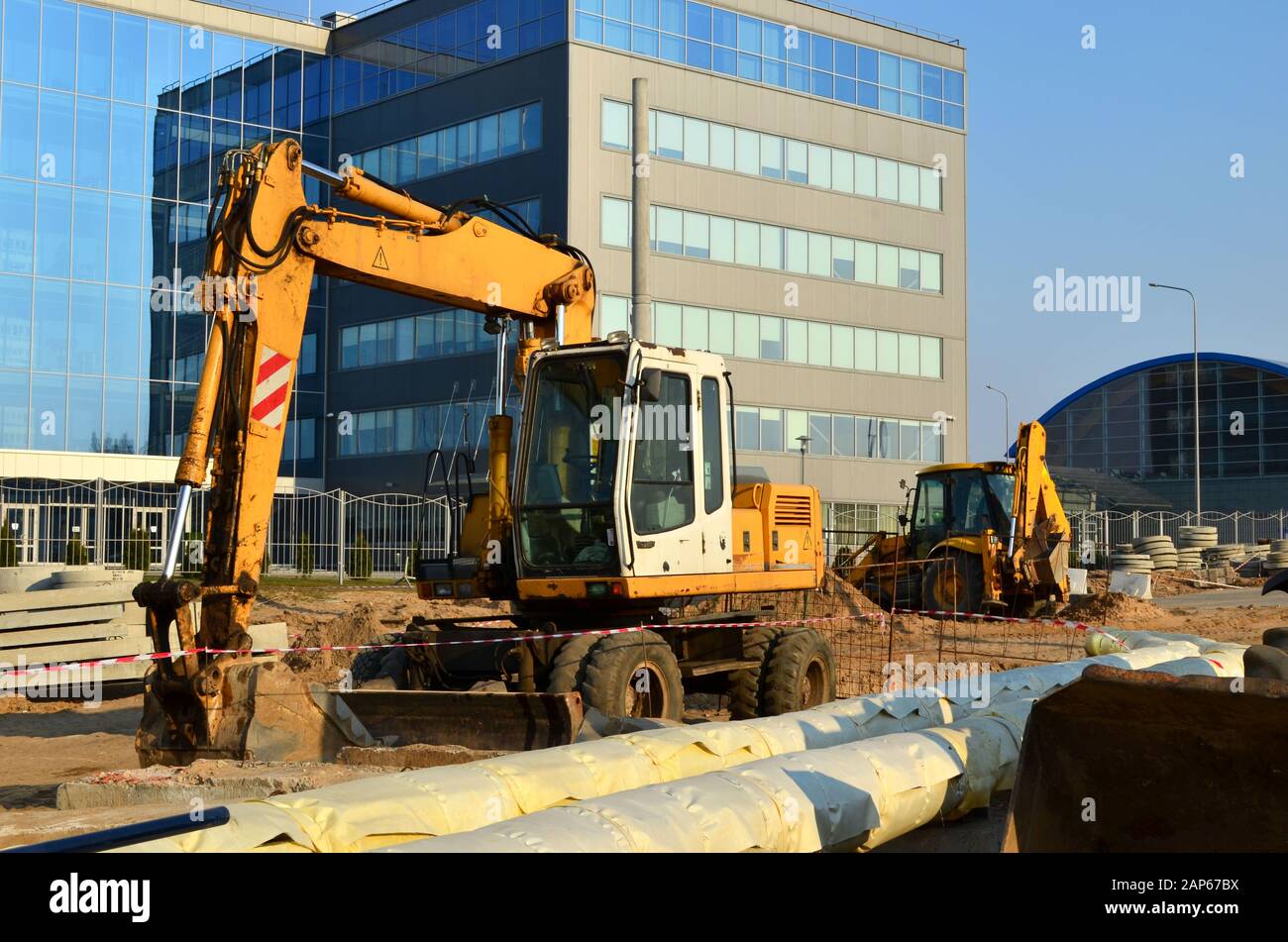 Heavy construction equipment and earthmoving excavators working on a ...