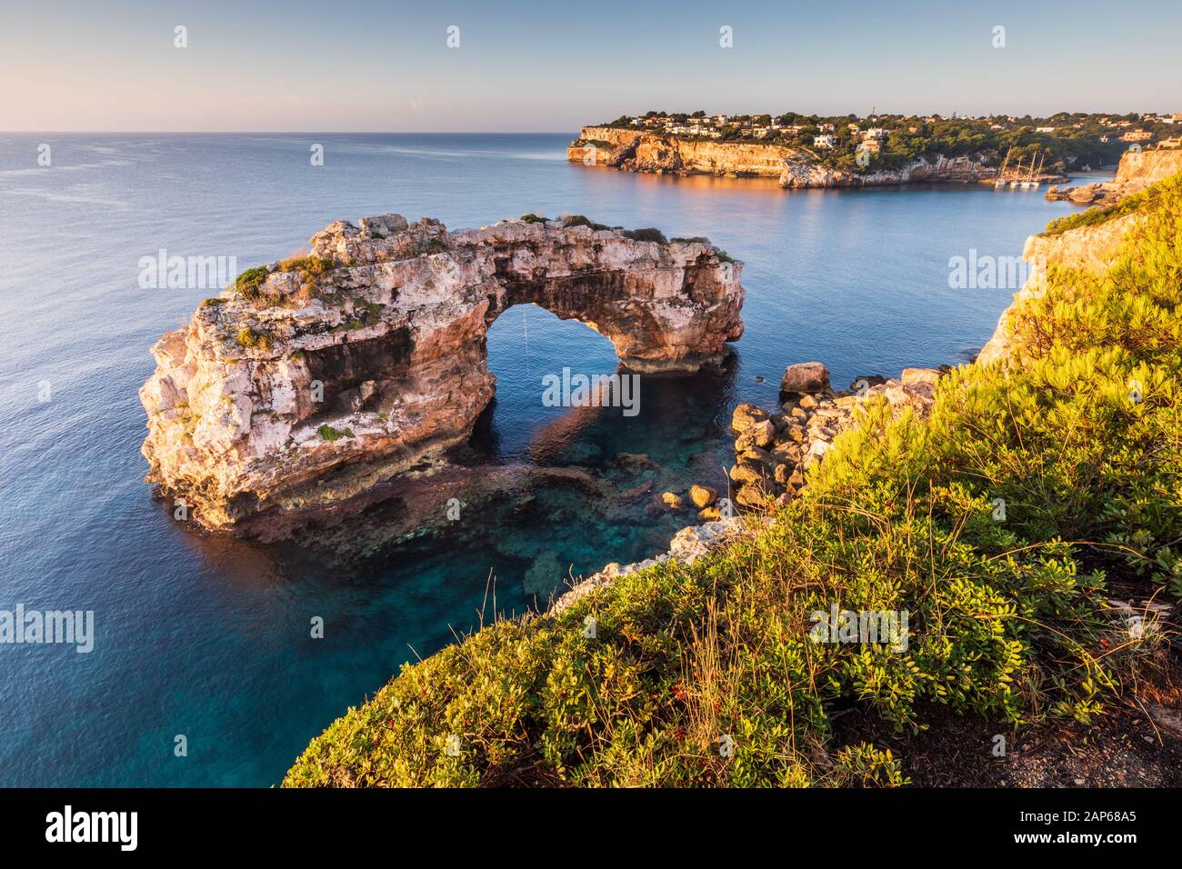 Es Pontas natural arch in Mallorca, Cala Llombards bay visible on the right Stock Photo