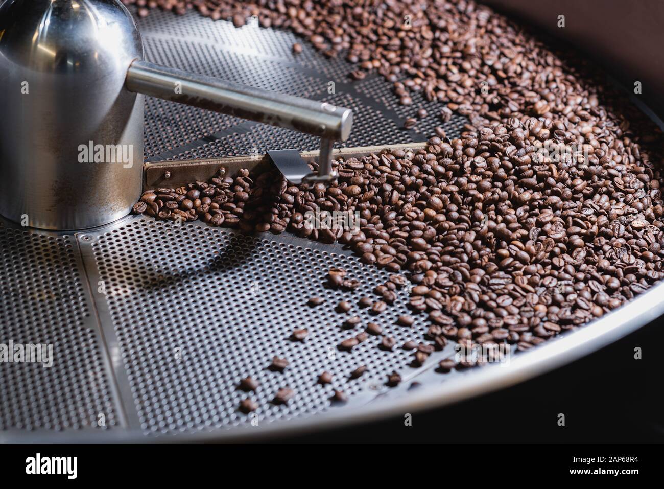 Roasting process of coffee. Coffee beans moved by the rotating shovel