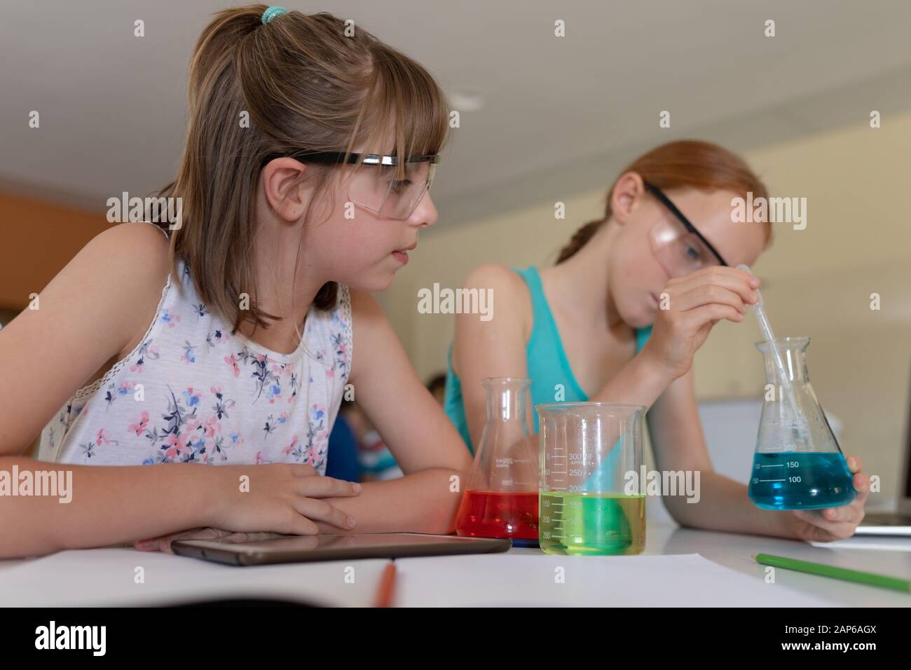 Two elementary school girls in chemistry class Stock Photo Alamy