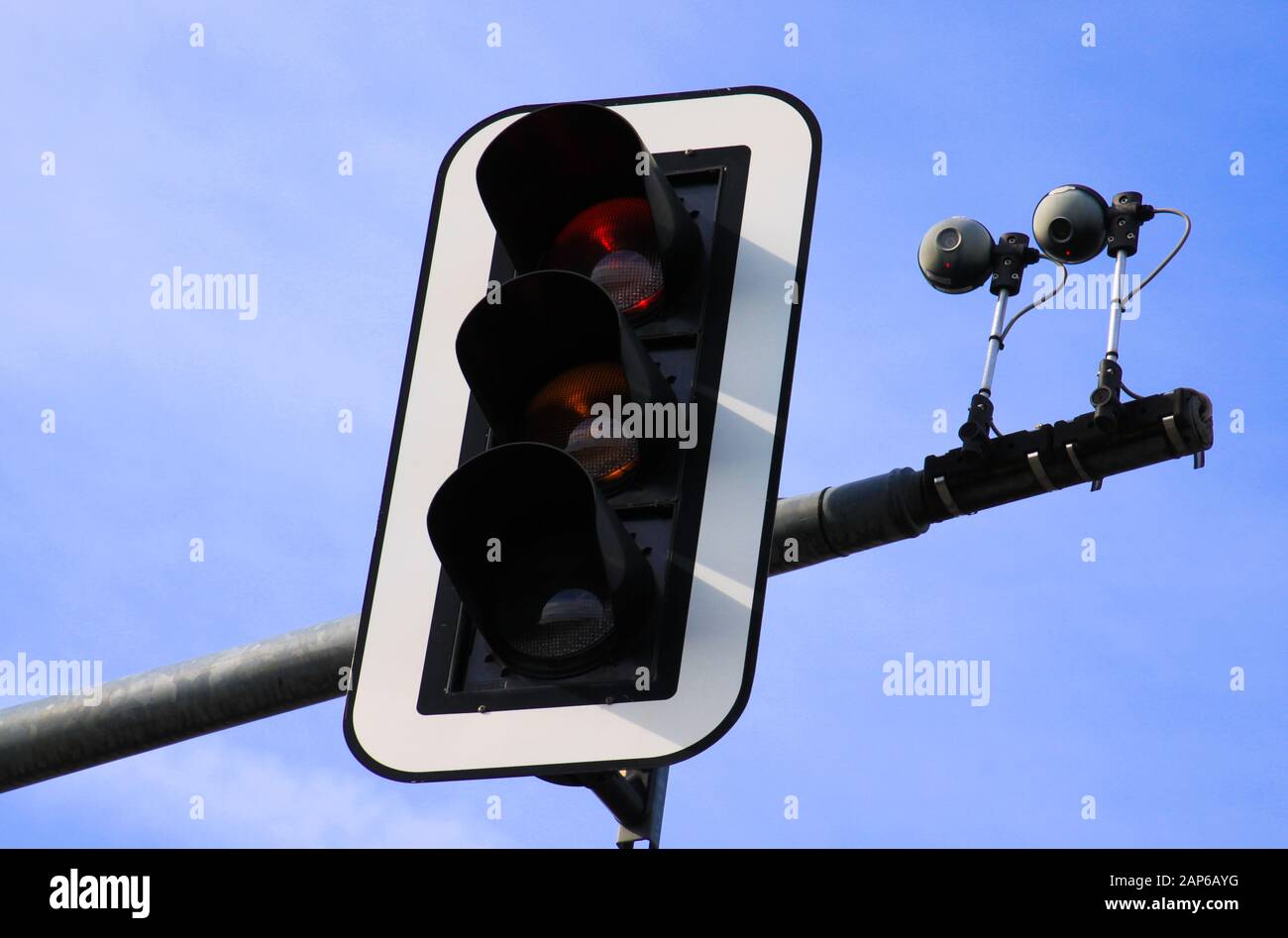 Intelligent traffic guidance in Germany: View on isolated radar based  cameras and detector with red traffic light against blue sky Stock Photo -  Alamy