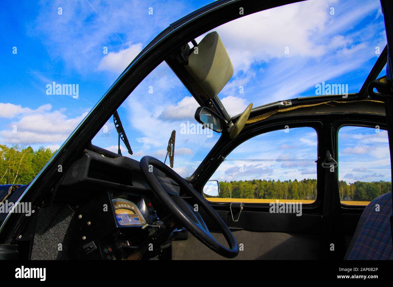 Viersen, Germany - October 12. 2019: View inside classic French cult car 2CV on front seat, dashboard and steering wheel with open folding roof and wi Stock Photo