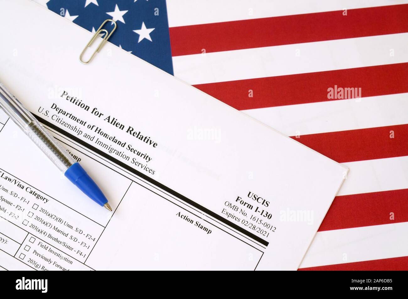 I-130 Petition for alien relative blank form lies on United States flag ...