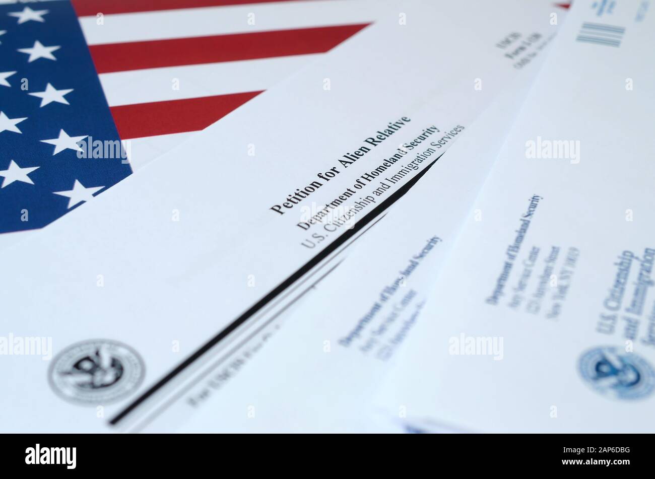 I-130 Petition for alien relative blank form lies on United States flag ...