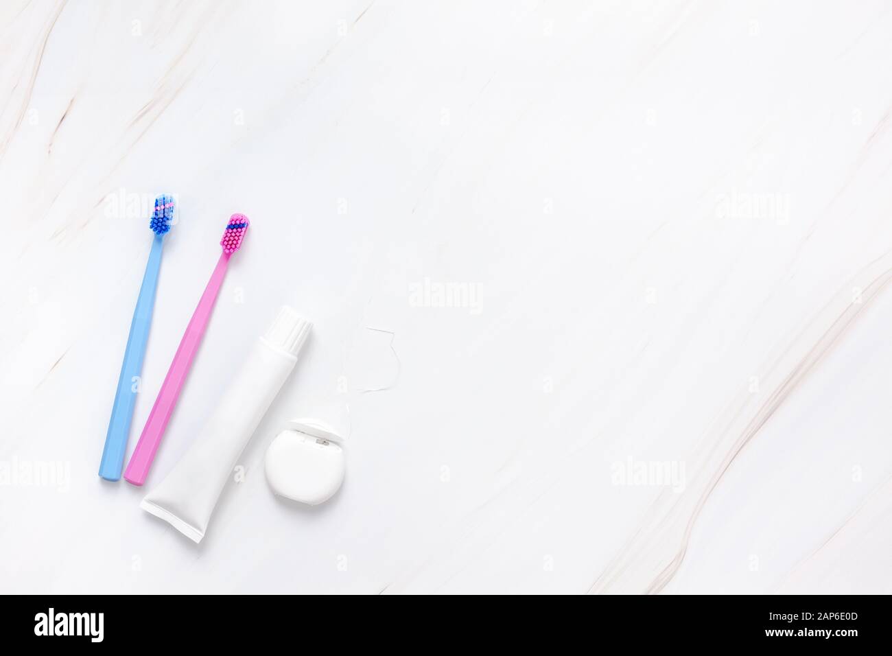 Teeth hygiene and oral dental care products on white marble table ...
