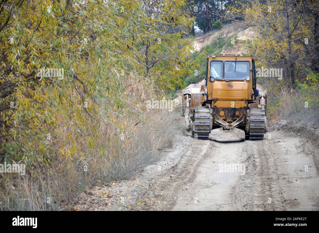 Quarry aggregate with heavy duty machinery on Construction industry. Caterpillar loader Excavator with backhoe driving to construction site quarry Stock Photo