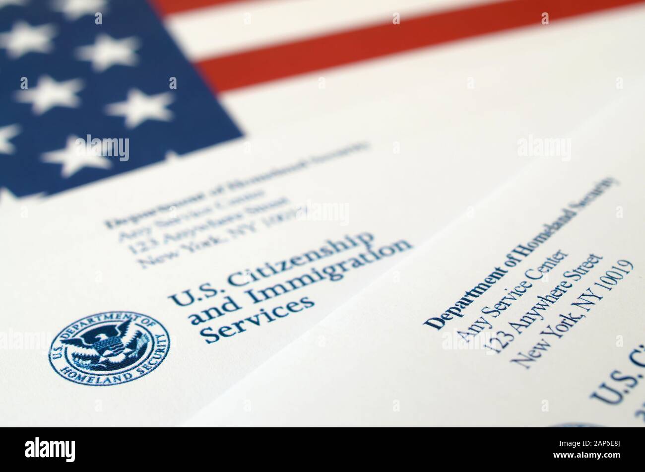 Envelopes with letter from USCIS on United States flag from Department