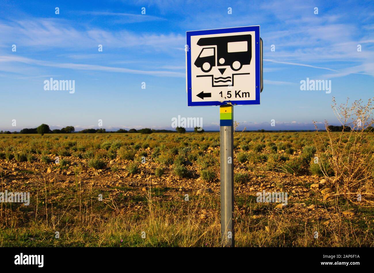 View on isolated white direction sign with camper against blue sky and lavender field. Sign gives information for next cesspool for feces disposal. Pr Stock Photo