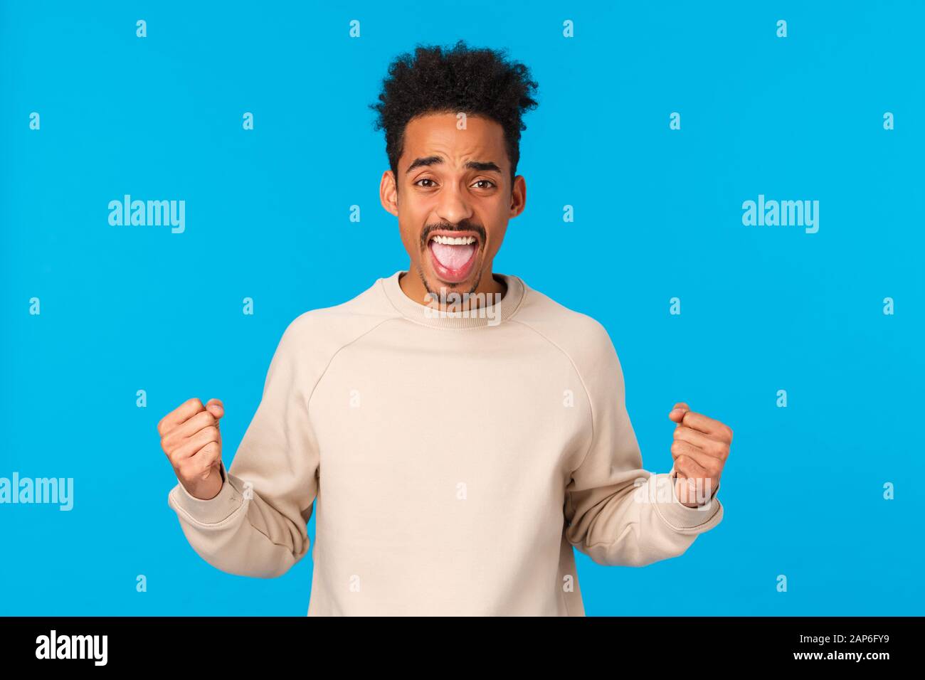 Cheerful And Excited Handsome African American Male With Afro