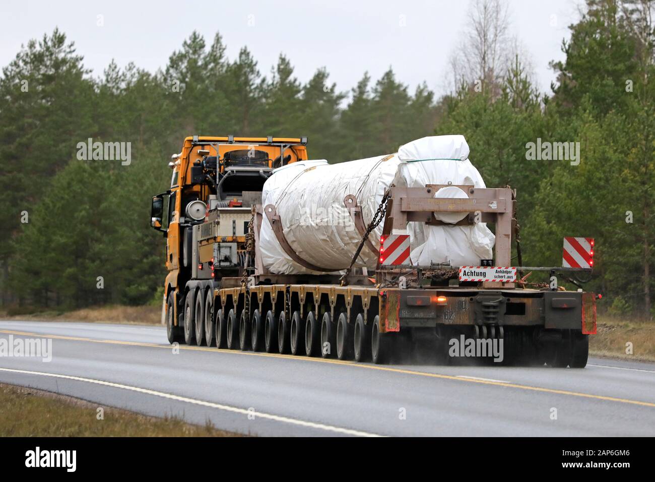 Yellow MAN TGX Bohnet GmbH semi multi axle low loader hauls industrial equipment as oversize load. Raasepori, Finland. Jan 17, 2020. Stock Photo