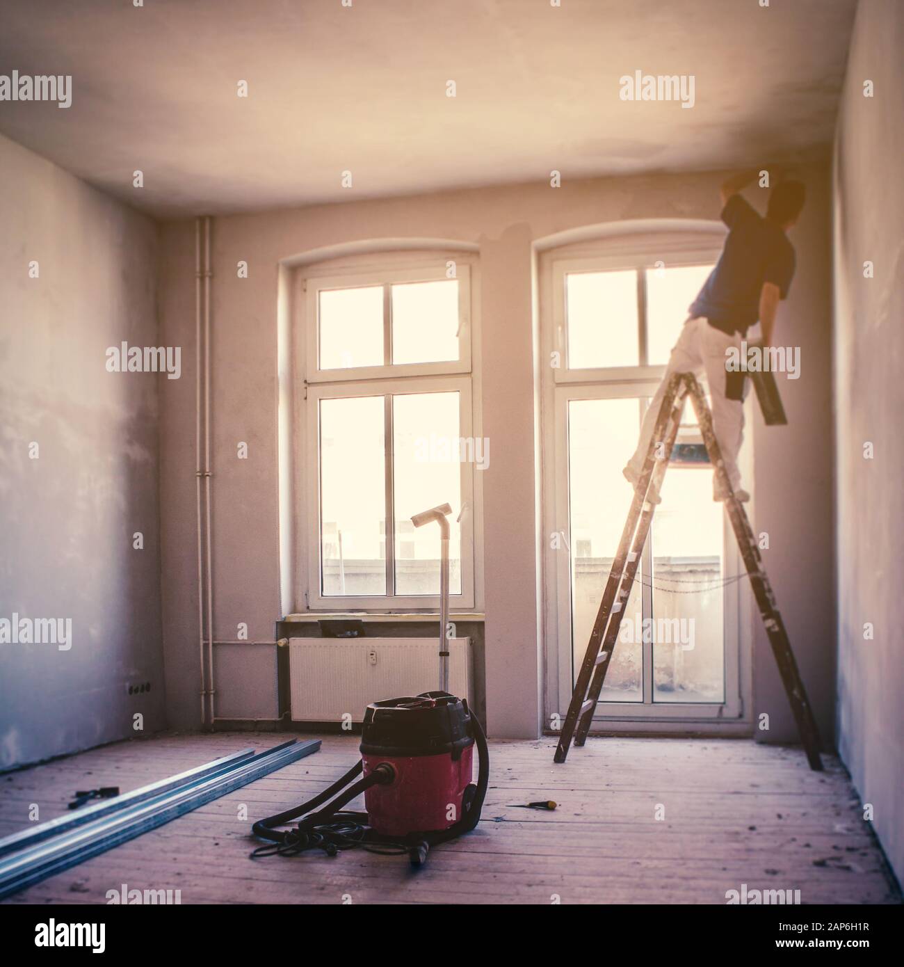 flat renovation concept, blur image of a  person on ladder renovate room Stock Photo