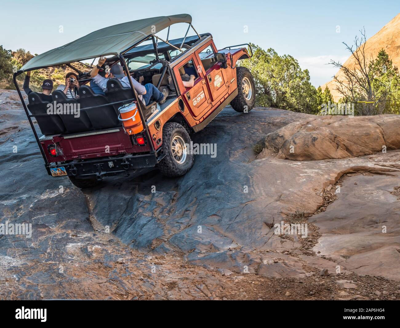 A Hummer lifts a tire climbing during a 4x4 Hummer tour on the Hell's