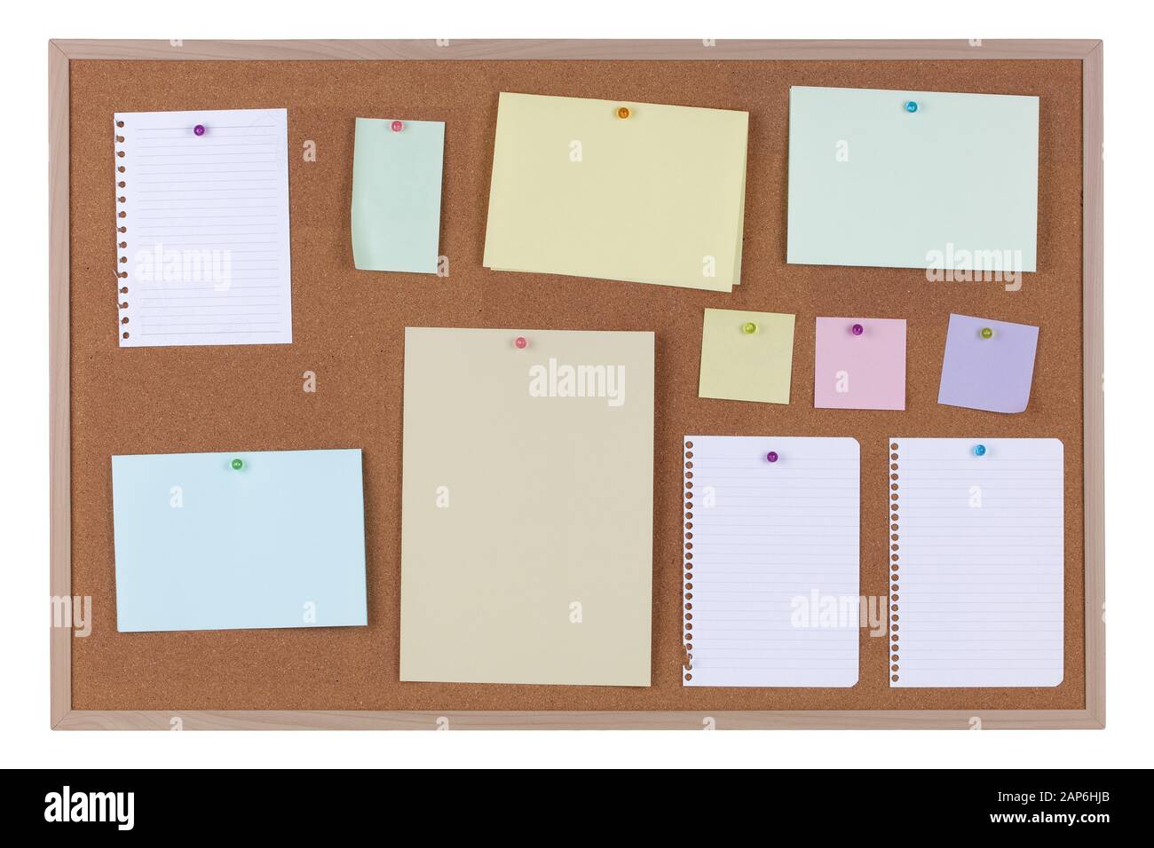 Paper reminder notices on a cork notice board on white background with clipping path Stock Photo