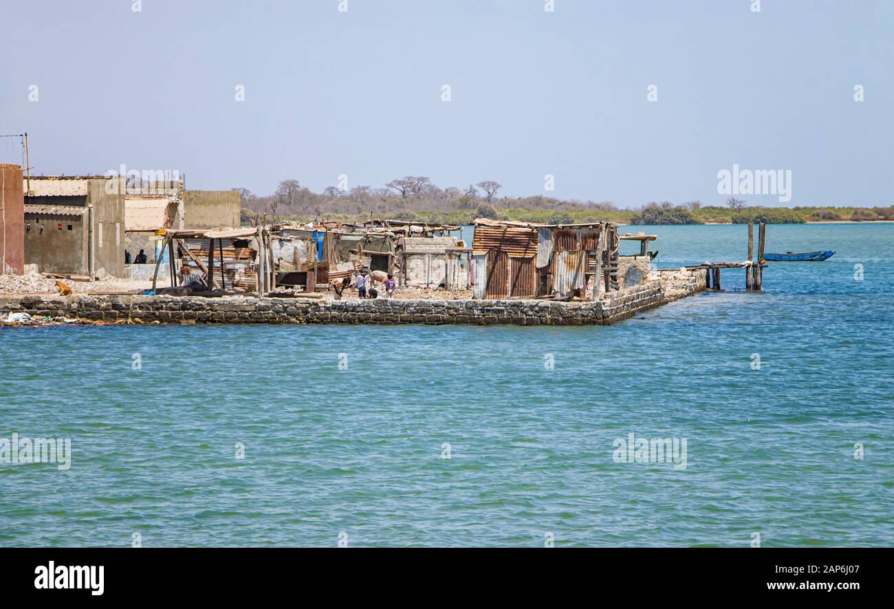 Fadiouth, Senegal, AFRICA - April 26, 2019: Unidentified Senegalese boys in front of the ruined houses in the village of Fadiouth, there are little Stock Photo