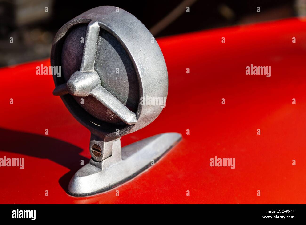 Vintage metal backview mirror on red car Stock Photo