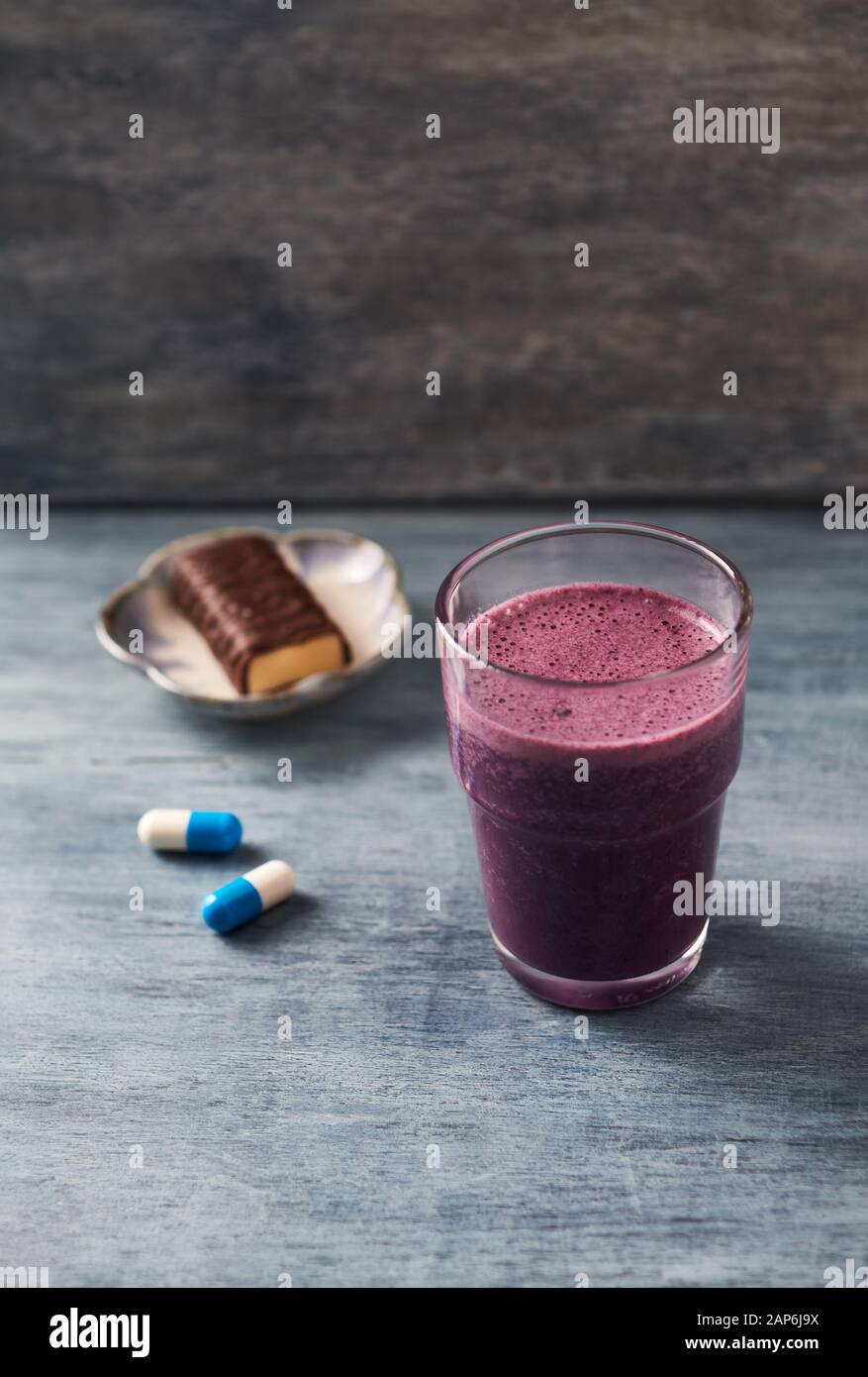 Glass of Protein Shake with milk and blueberries, Creatine capsules and  Protein bar. Concept for Sport nutrition Stock Photo - Alamy