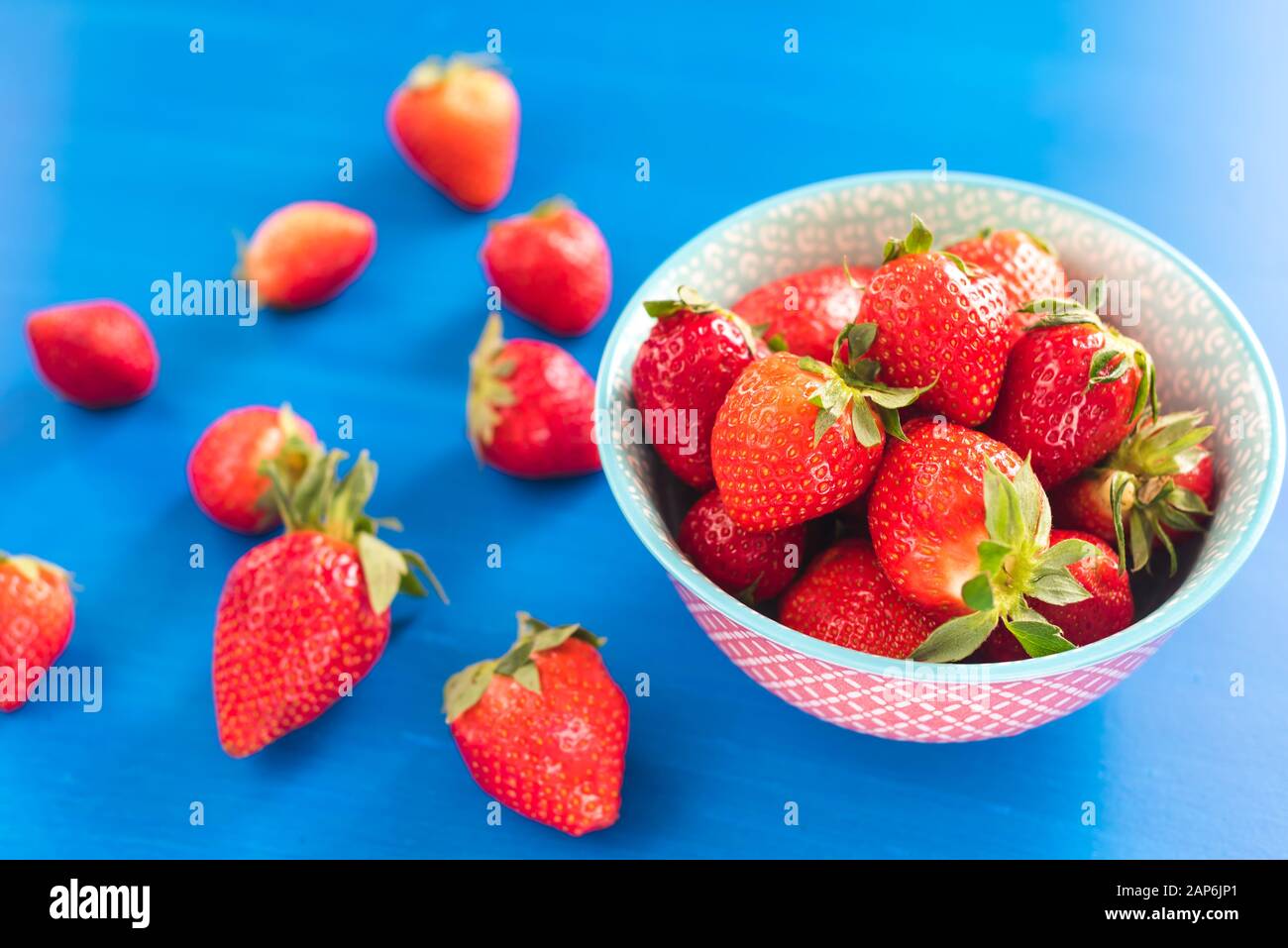 strawberries in a colorful bowl on colorful background Stock Photo - Alamy
