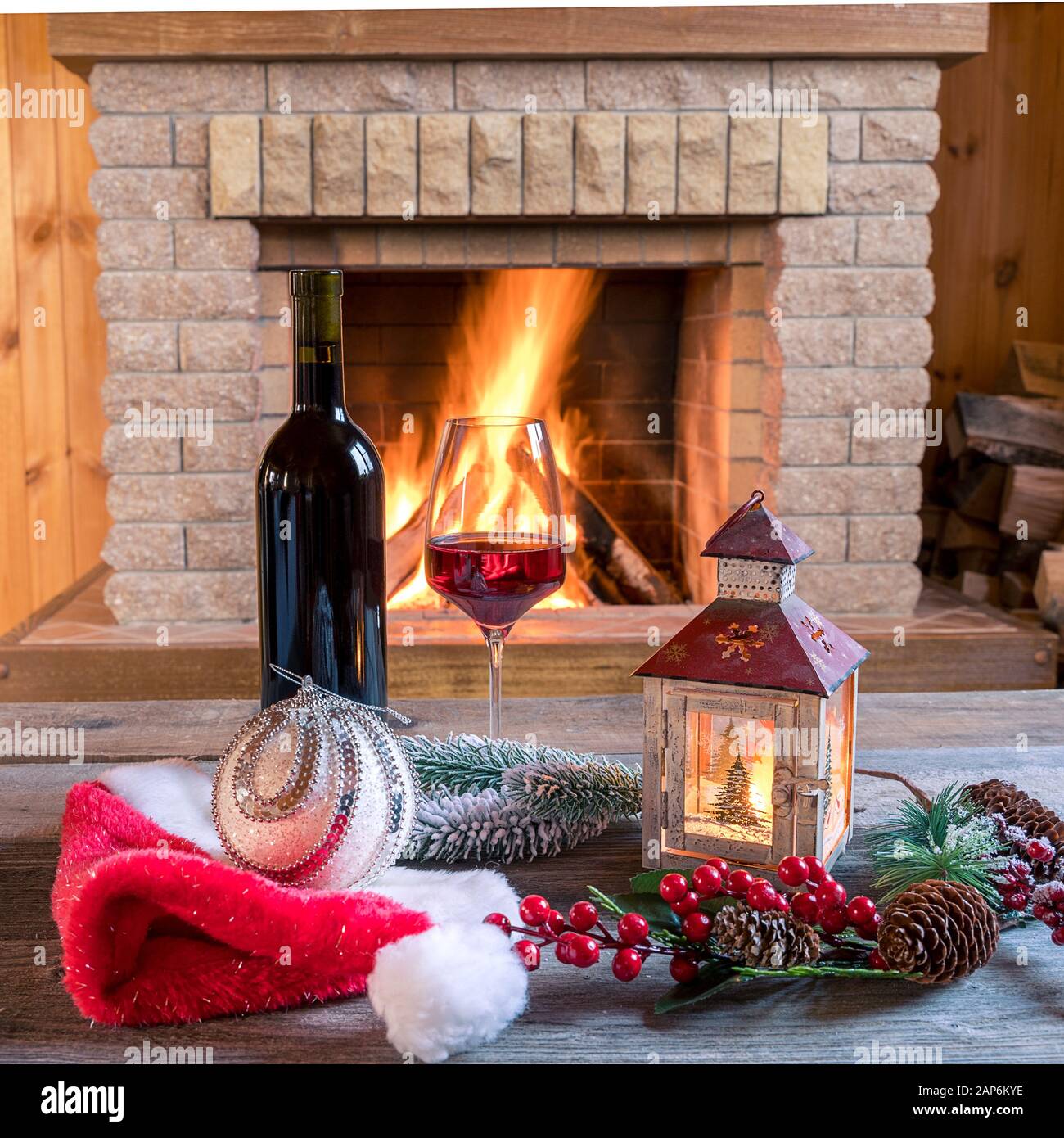 Christmas lantern , red wine and christmas decorations near cozy ...