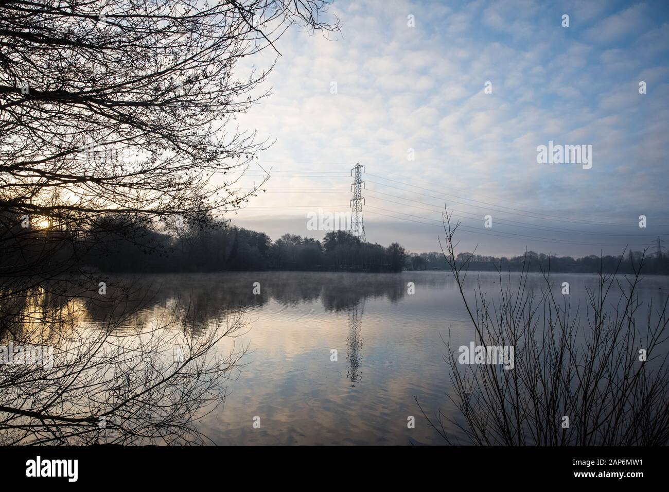 Harefield, UK. 21 January, 2020. The sun rises behind a lake in Colne Valley Regional Park across which a 3.4 km-long viaduct would be constructed should plans for the HS2 high-speed rail link be approved. Credit: Mark Kerrison/Alamy Live News Stock Photo