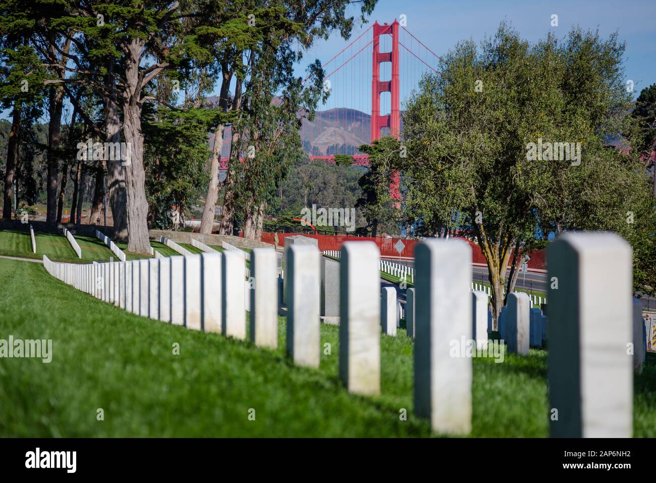 Military Tombstones at cemetery with Golden Gate Bridge on the background Stock Photo