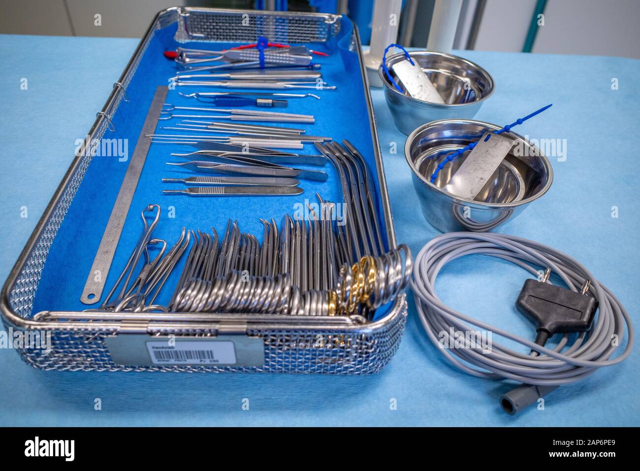in an operating room, there's a sieve for hand surgery on a blue sheet