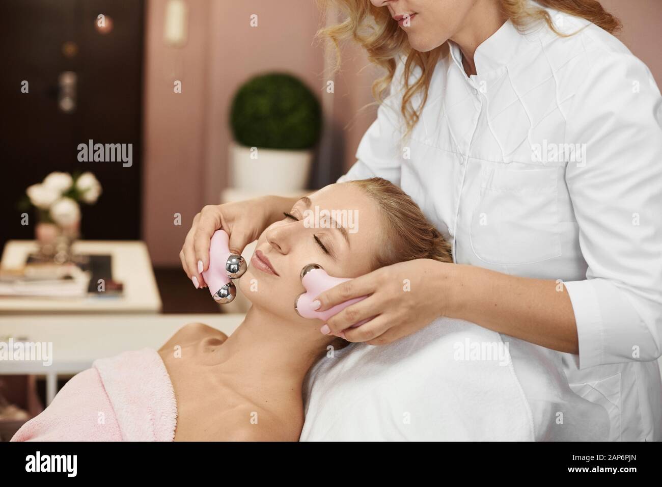 Beautiful Young Woman Receiving Microcurrent Procedure For Lifting Skin By Beautician Therapist Facial Rejuvenation And Facelift With Galvanic Stock Photo Alamy