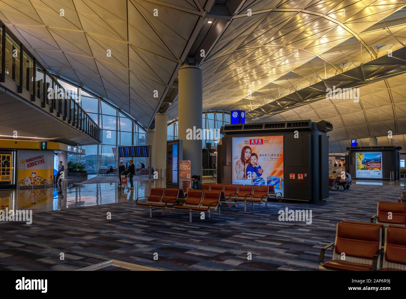 Interior view of seating and Chinese signage at a terminal in Hong Kong Airport. Stock Photo