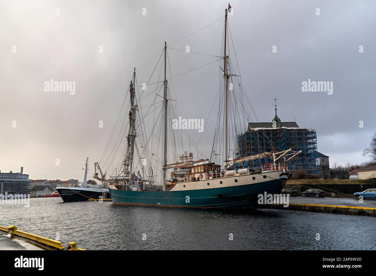 Sailing vessel, the tall ship barquentine Antigua in the port of Bergen, Norway.  Berthed adjacent Nykirkekaien near the ancient Rosenkrantz Tower. Stock Photo