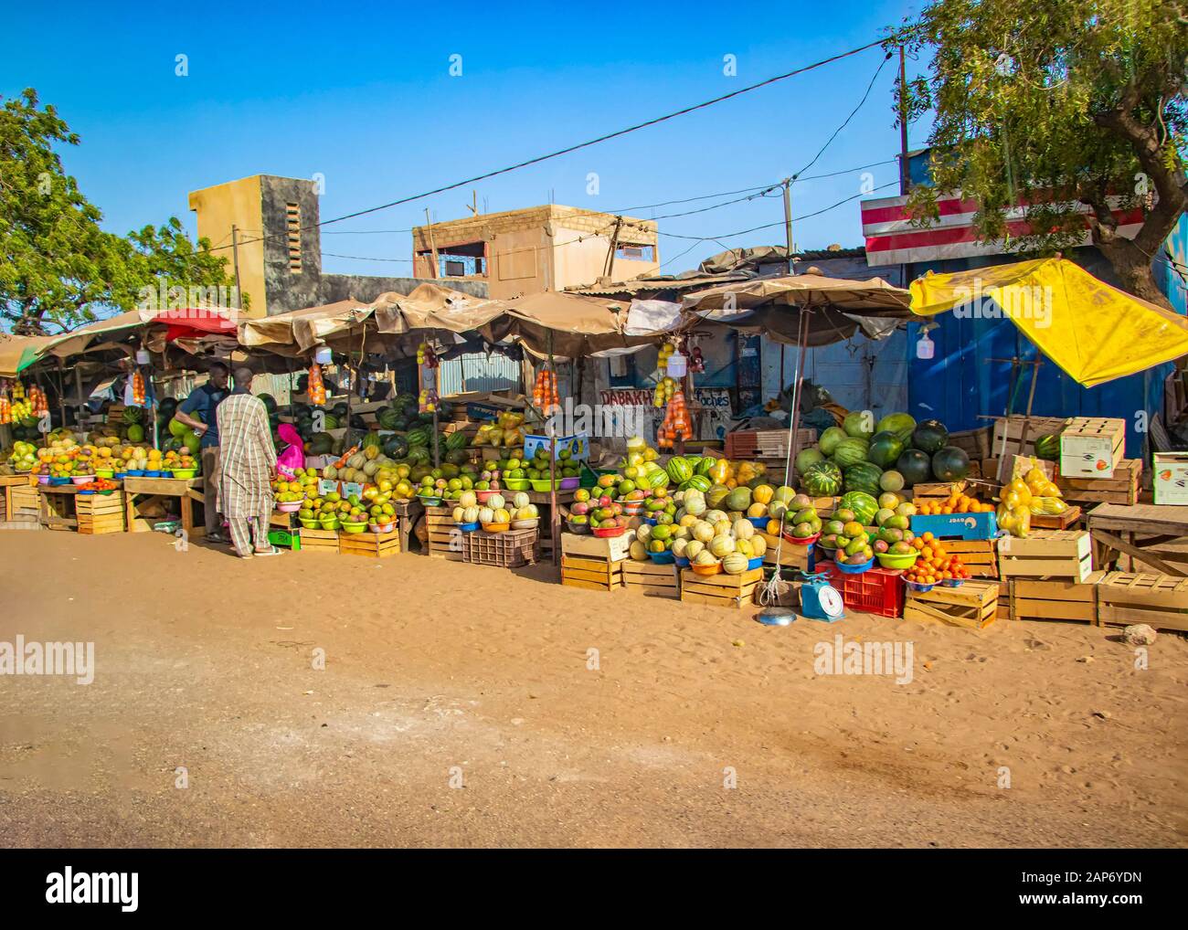 MBour, Senegal, AFRICA - April 22, 2019: Street fruit market where locals sell tropical fruits like melons, mangoes, oranges, lemons and more. Stock Photo
