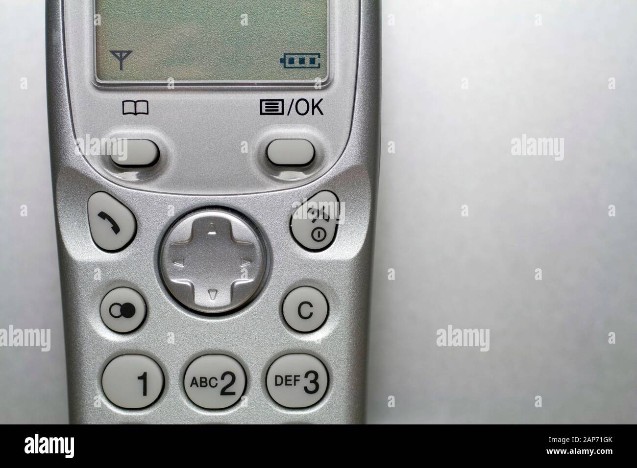 Close up shot of a silver cordless phone from the early 2000's Stock