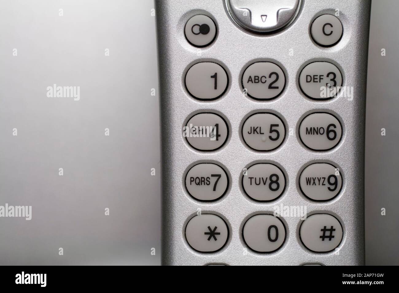 Close up shot of a silver cordless phone from the early 2000's Stock