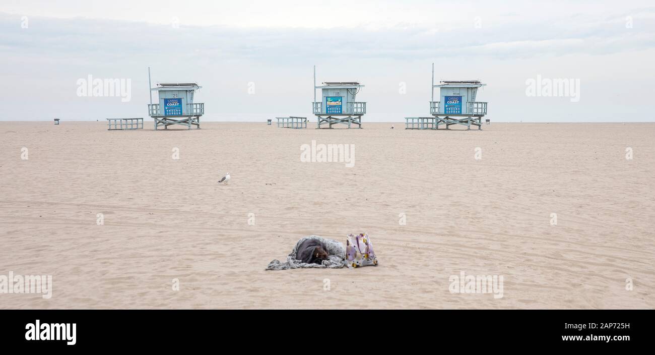 Homeless person on the beach at Venice, Los Angeles, CA, USA Stock Photo