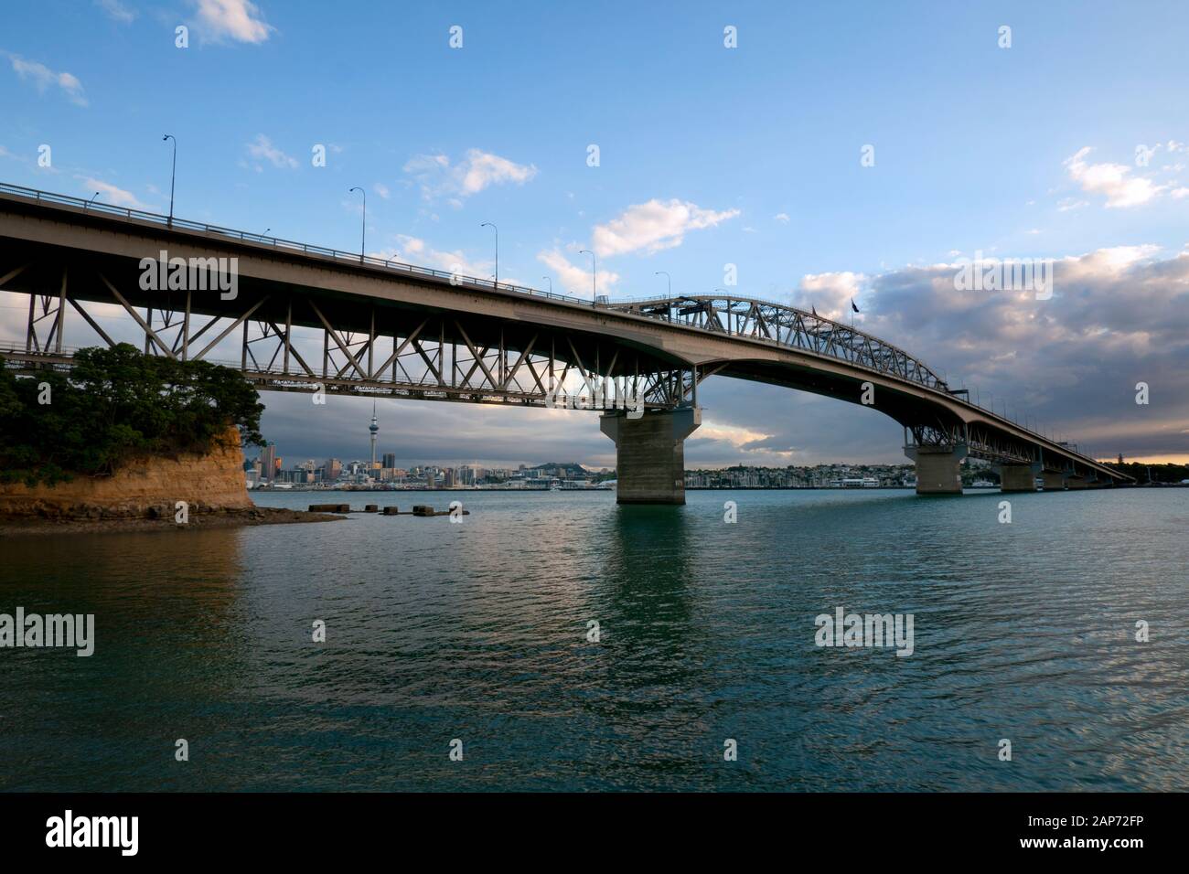 Looking over Waitemata Harbour at downtown Auckland city from the North Shore with the Harbour Bridge in foreground. New Zealand. Stock Photo