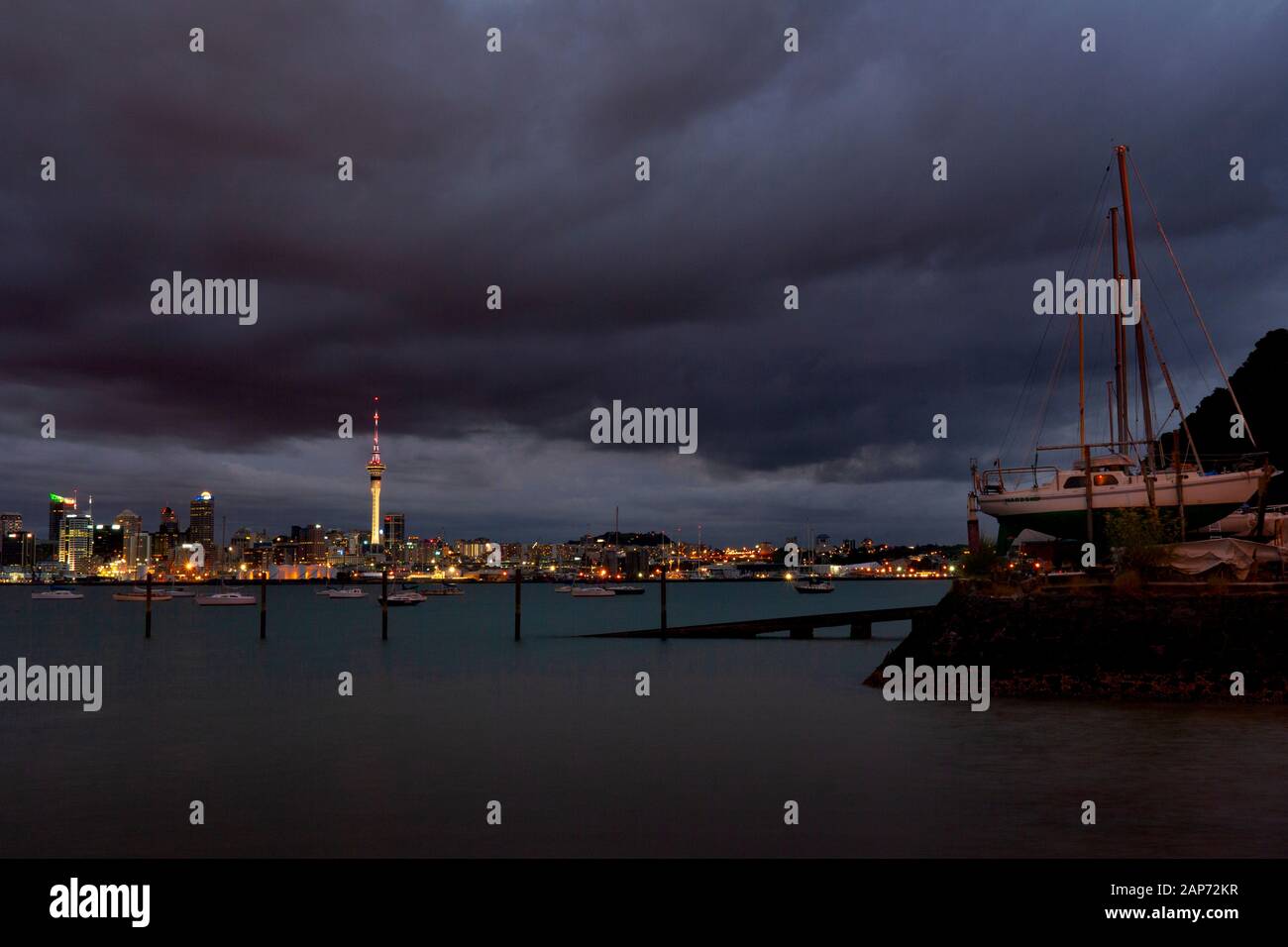 Looking over the Waitemata Harbour towards Auckland city from the North Shore at night. New Zealand. Stock Photo