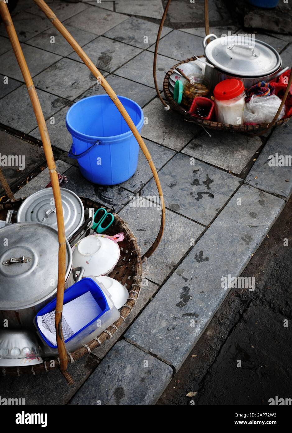 Traditional Vietnamese metal kitchen utensils for preparing and serving