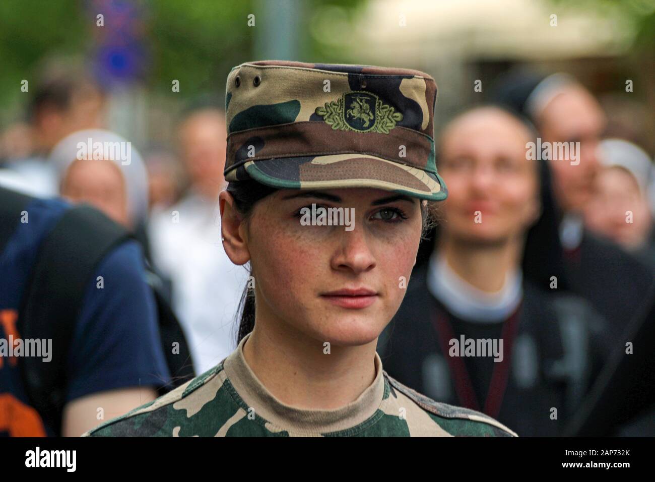 Young Lithuanian female soldier staring focused ahead Stock Photo