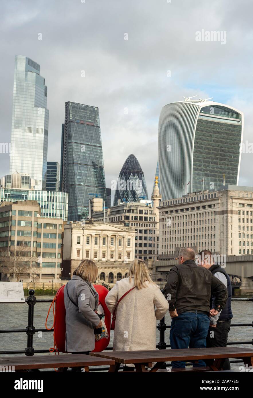 Group of tourists at Pickfords Wharf enjoying the view over River Thames to the City of London as of 2020 Stock Photo