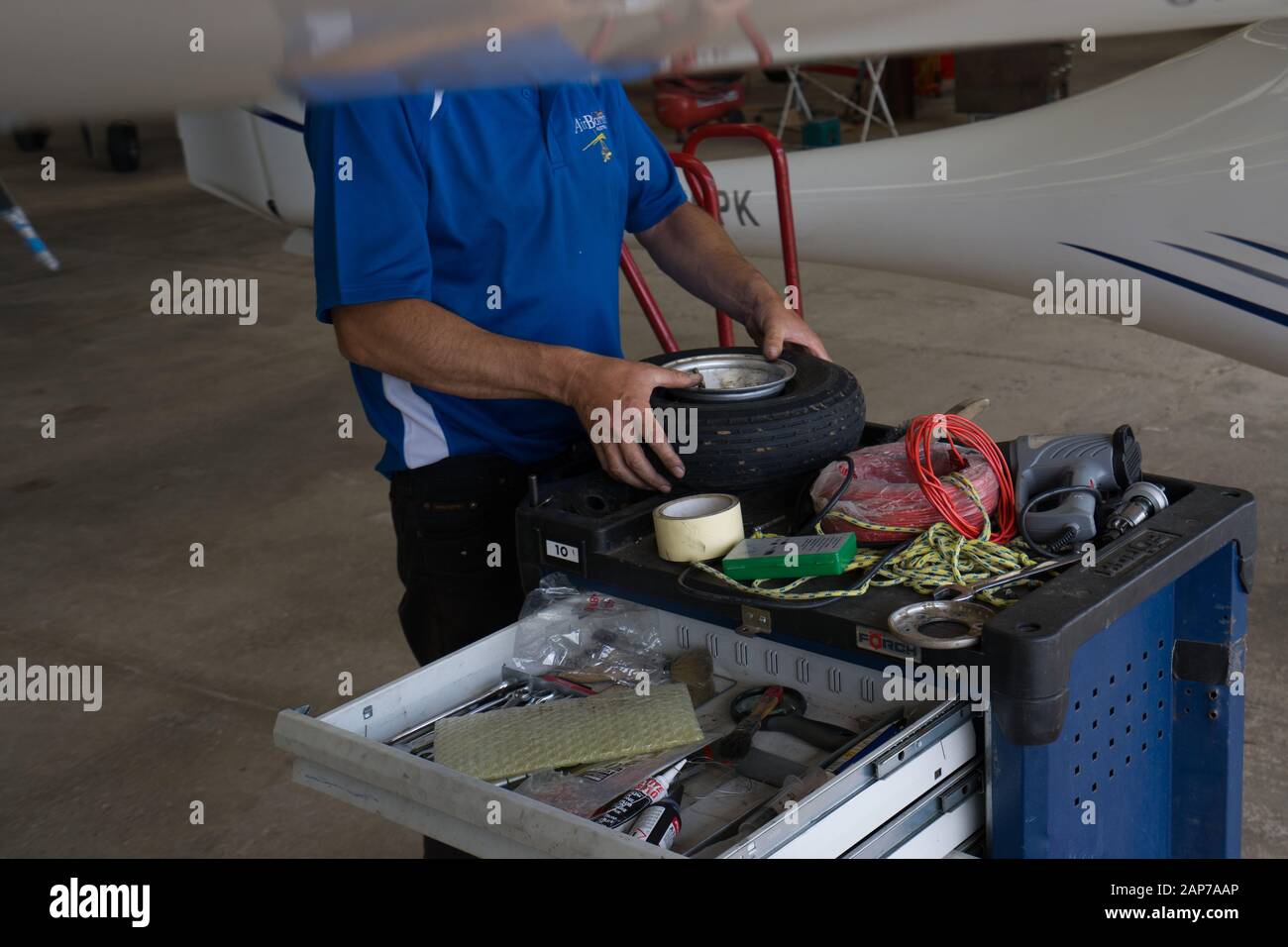 Microlight Ultralight aircraft changing flat tire Stock Photo Alamy