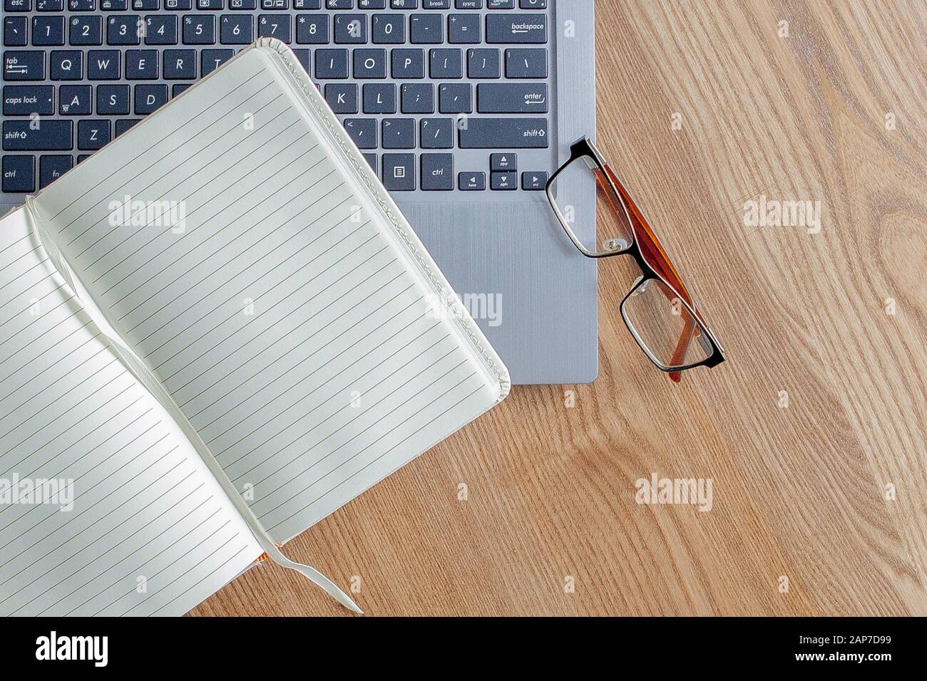 Notepad Laptop And Glasses On Old Wooden Desk View From Above