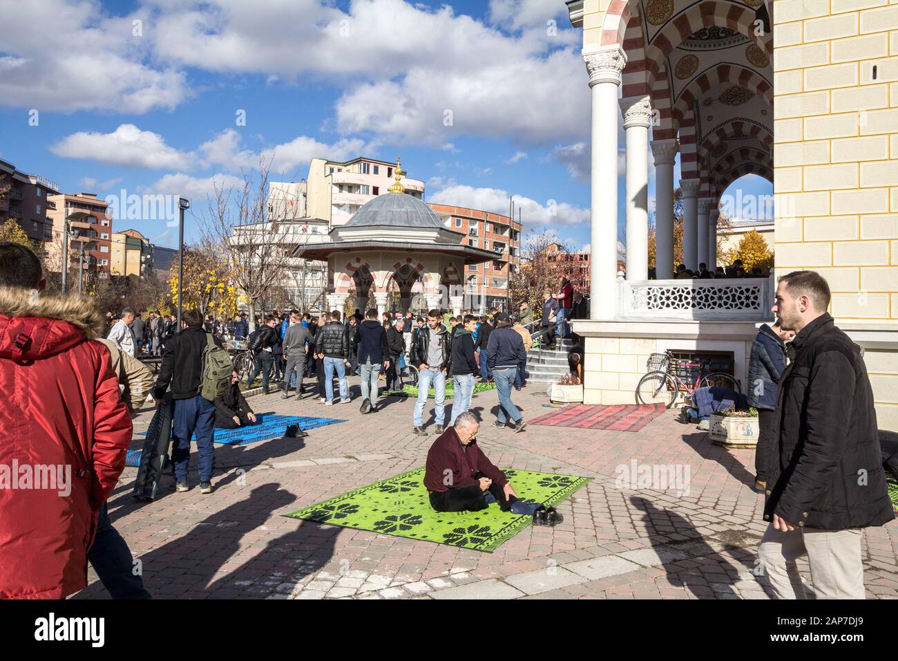 MITROVICA, KOSOVO - NOVEMBER 11, 2016: Kosovo Albanian muslims praying in front of the Isa Beg Mosque, Mitrovica. Isa Beg mosque is an islamic landmar Stock Photo